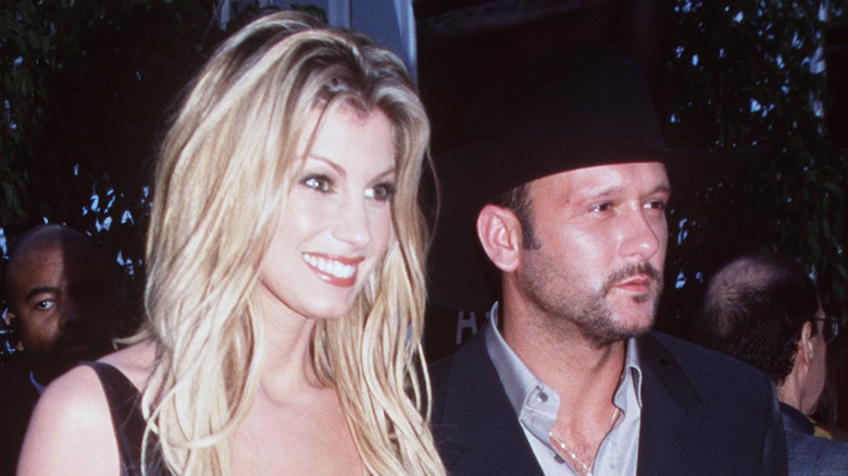 Faith Hill and Tim McGraw smiling and posing together