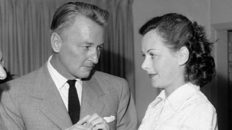 Teddy Stauffer fixes his eyes on Hedy Lamarr as he places a ring on her finger.