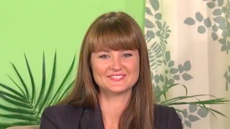 Kristan Cunningham posing in front of a green background