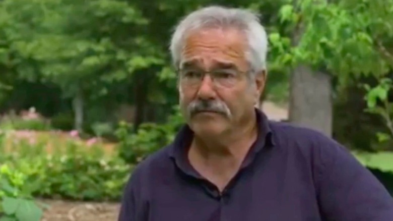 Paul James photographed in front of trees