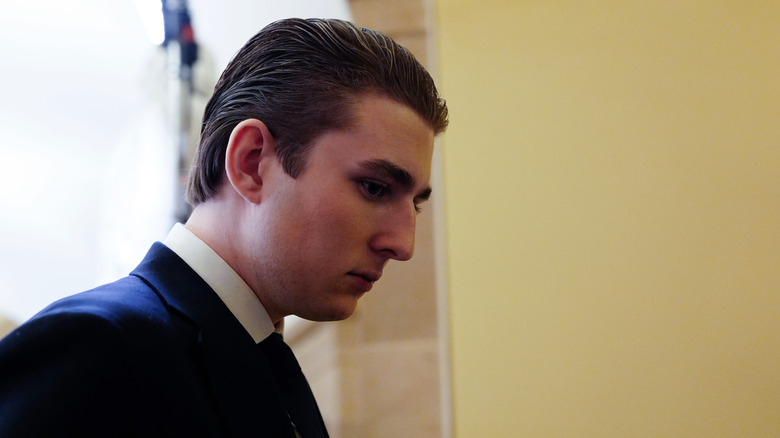 Barron Trump looking down.