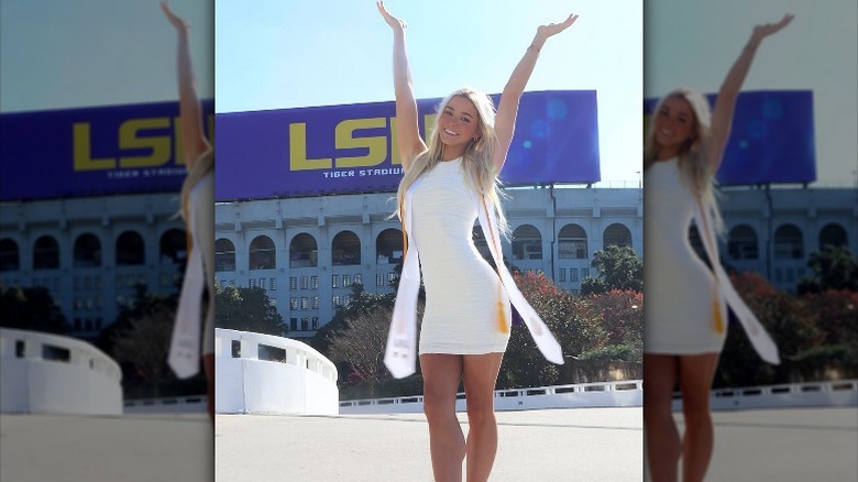 Olivia Dunne poses with arms raised in front of LSU after graduating (2024)