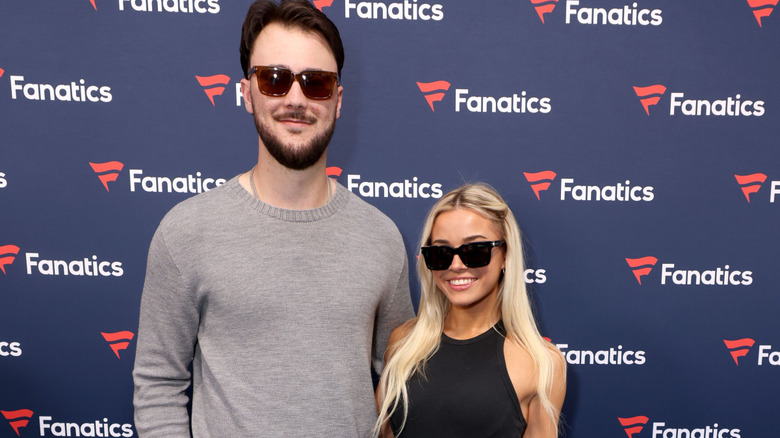 Paul Skenes and Olivia Dunne wearing sunglasses