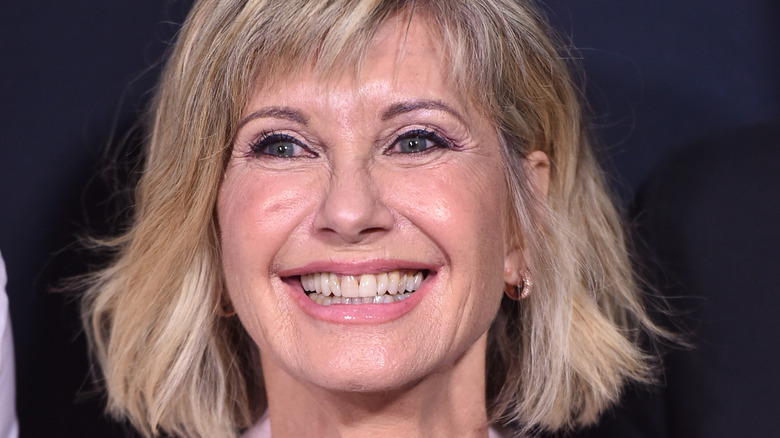 Olivia Newton-John in pink jacket