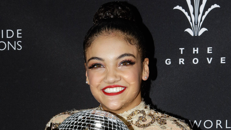 Laurie Hernandez smiling with the Mirrorball Trophy