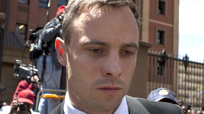 Oscar Pistorius looking down outside court