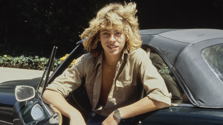 Leif Garrett posing for a photo with a car circa 1980
