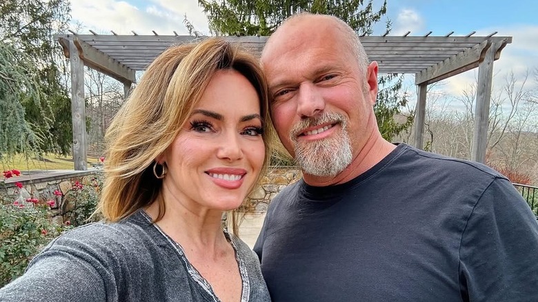 Lisa Robertson and Jeff Lawrence posing for cameras on their farm