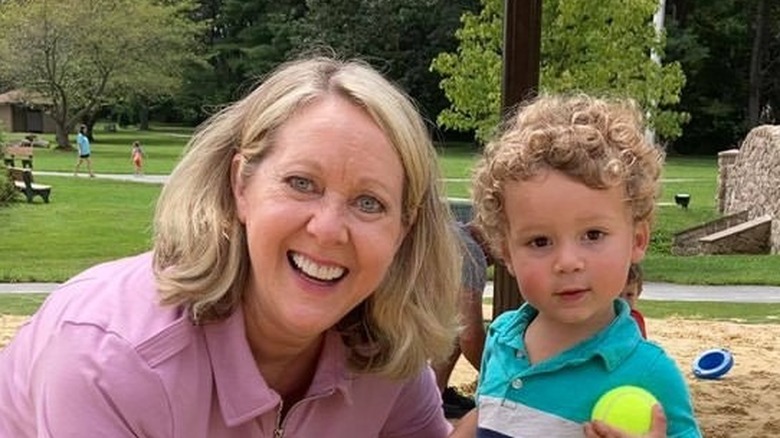 Mary Beth Roe playing with grandson in a park
