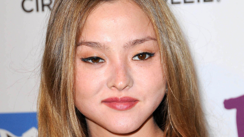 Devon Aoki smiling on the red carpet