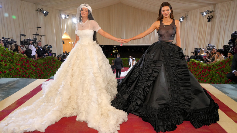 Kendall and Kylie Jenner hold hands at the 2022 Met Gala.