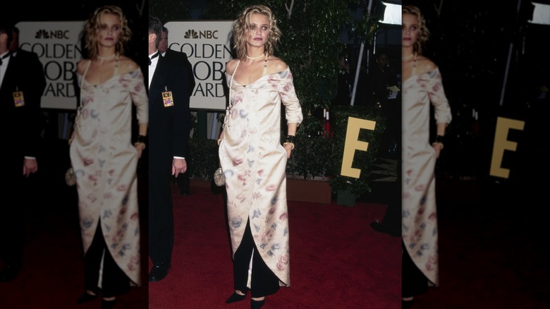 Cameron Diaz wears a floral dress over black pants on the red carpet.