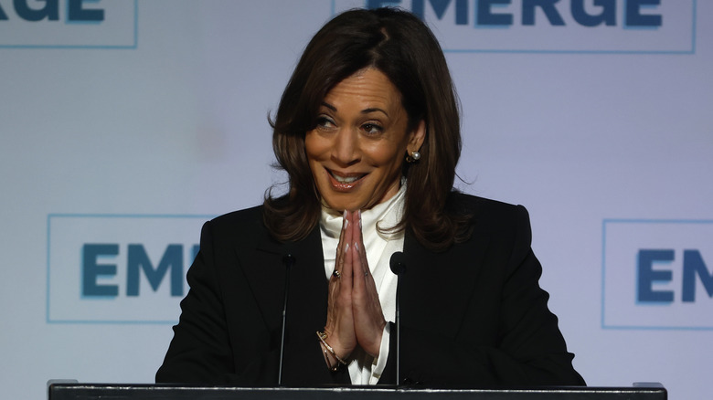 Kamala Harris pushing her hands together during a speaking event