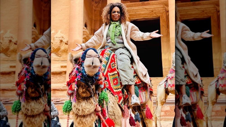 Oprah riding on camel's back