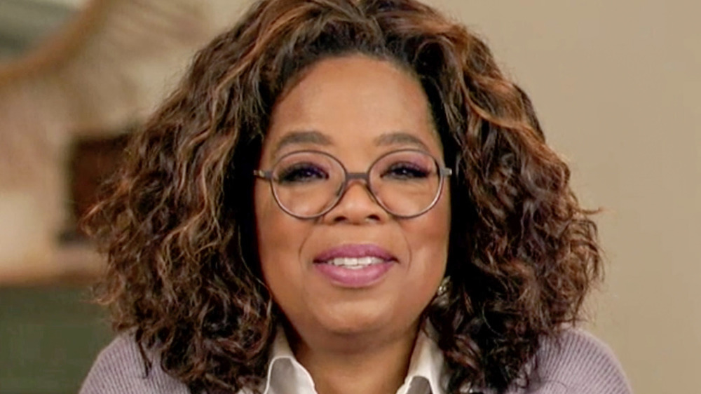 Oprah Winfrey smiling during a virtual meeting