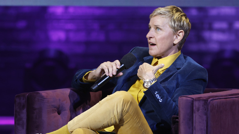 Ellen DeGeneres sitting and talking into a microphone.