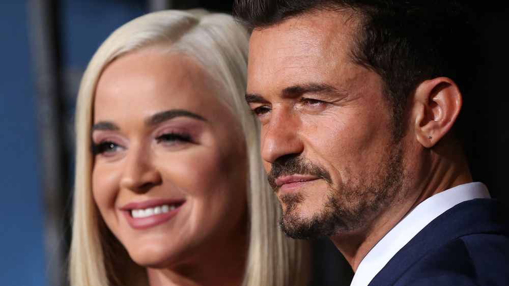 Katy Perry and Orlando Bloom smiling together at an event