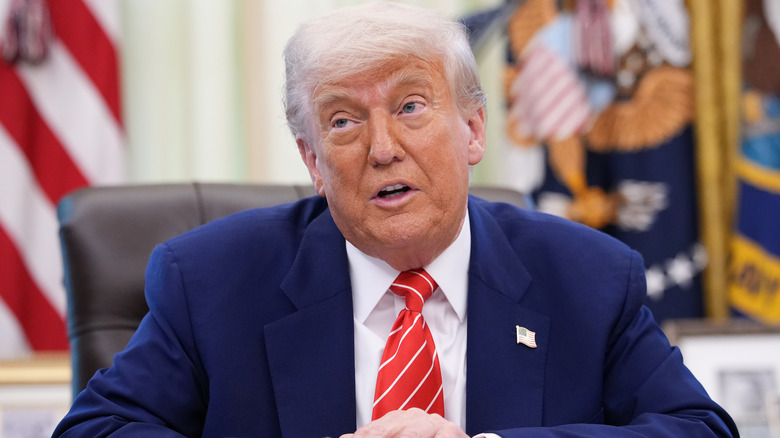 Donald Trump sitting at his desk