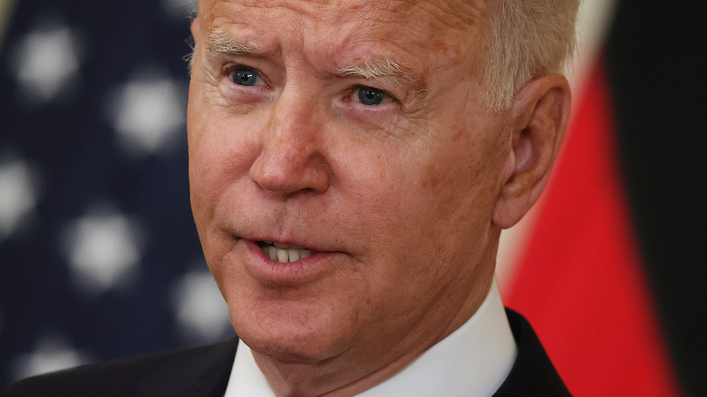 Joe Biden speaking in front of American flag