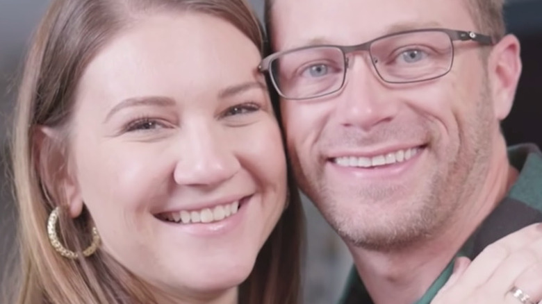 Danielle Busby and Adam Busby smiling big cheek-to-cheek