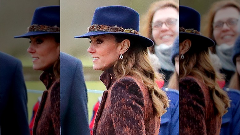 Kate Middleton wearing an electric blue fedora hat and brown coat