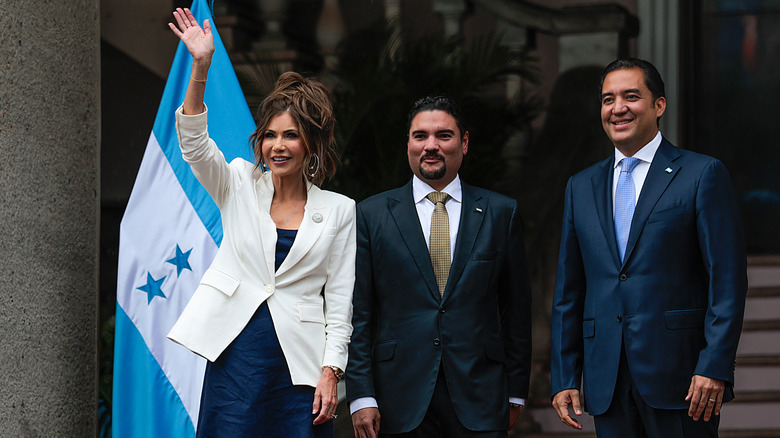 Kristi Noem posing outside the Casa Presdencial in Honduras.