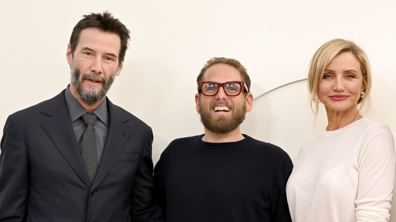 Jonah Hill posing with Keanu Reeves and Cameron Diaz