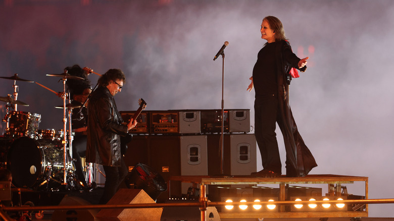 Tony Iommi and Ozzy Osbourne rocking out on stage