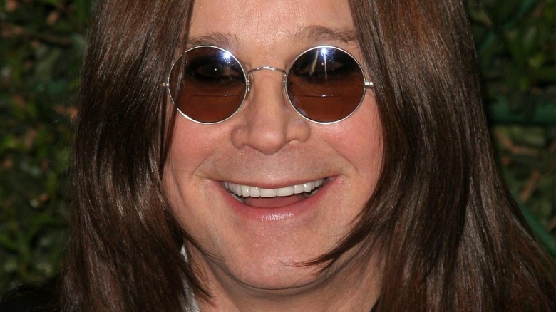Ozzy Osbourne smiling in sunglasses