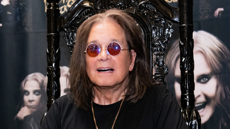 Ozzy Osbourne seated at a table
