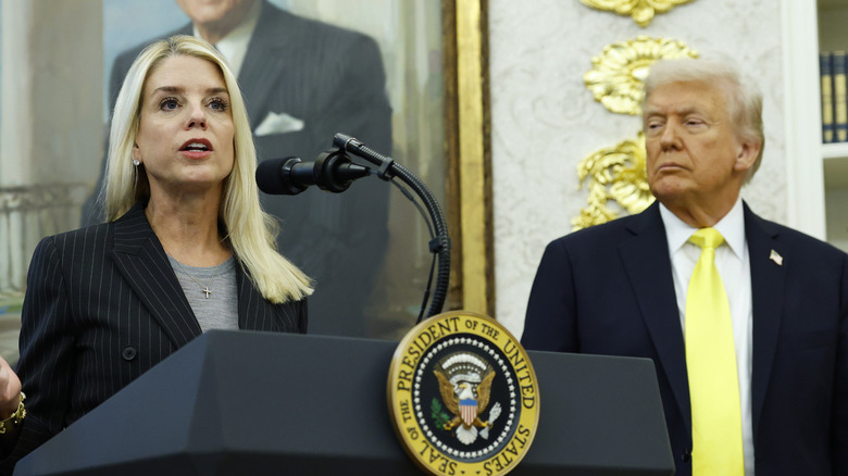 Pam Bondi speaking next to Donald Trump