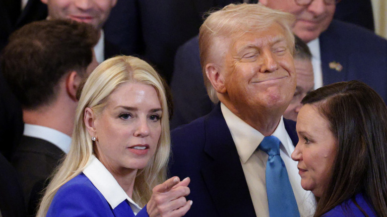 Pam Bondi pointing next to Donald Trump