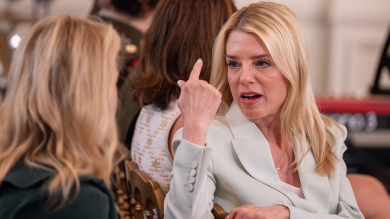 Pam Bondi speaking animatedly to someone at the White House.