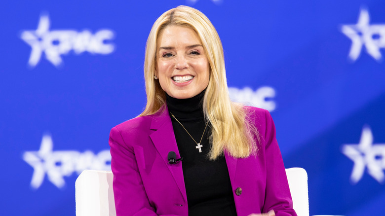 Pam Bondi smiling at a conference in 2025.