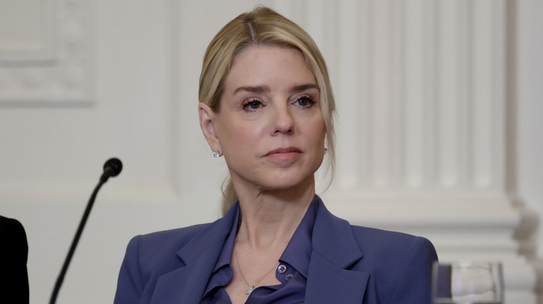 Bondi listening at a 2026 meeting.