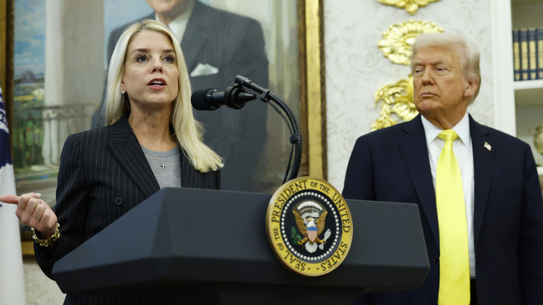 Bondi speaks in 2025 as President Trump looks on.