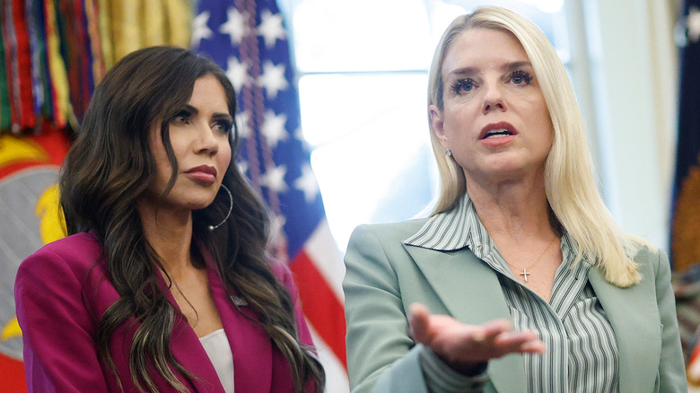 Pam Bondi speaks in the Oval Office while Kristi Noem looks on.