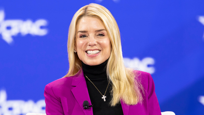 Pam Bondi baring her teeth at a 2025 conference.