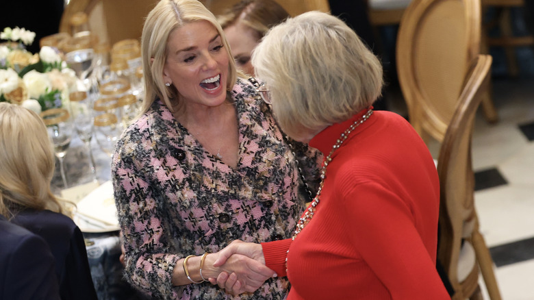 Pam Bondi shaking hands at luncheon