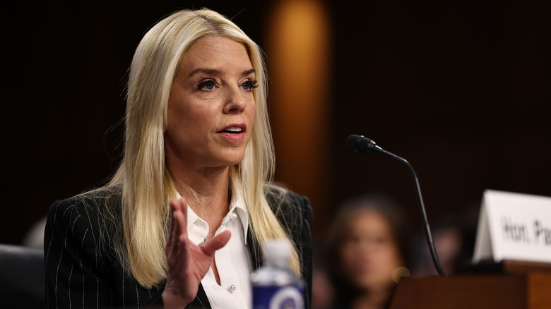 Pam Bondi speaks into a microphone