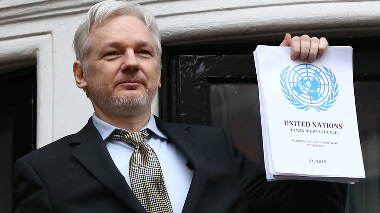 Julian Assange photographed with document