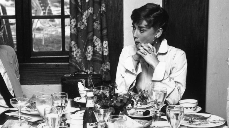 Audrey Hepburn eating on set