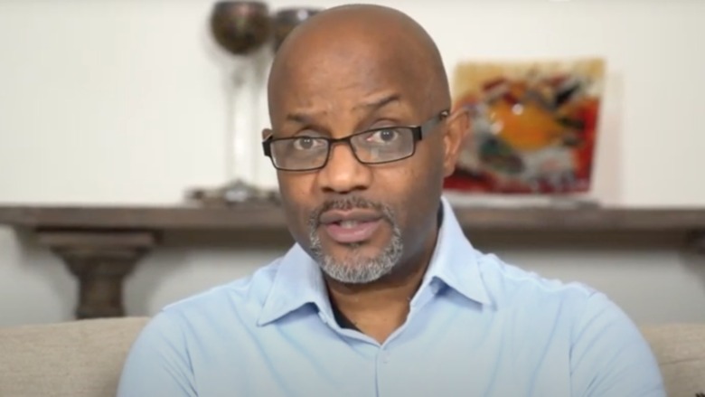 Pastor Calvin Roberson raising one eyebrow and speaking into the camera 