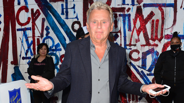 Pat Sajak shrugs to the camera