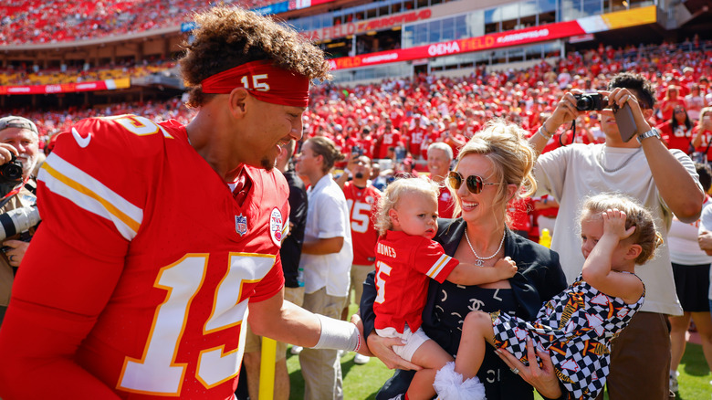 Patrick Mahomes greets his wife, Brittany Mahomes, and two of their children.