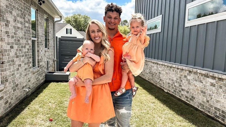 The Mahomes family posing outdoors
