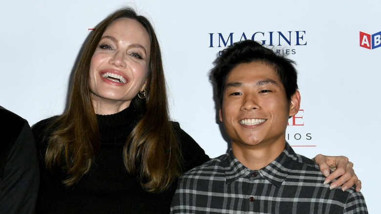 Angelina Jolie and Pax laughing on a 2021 red carpet