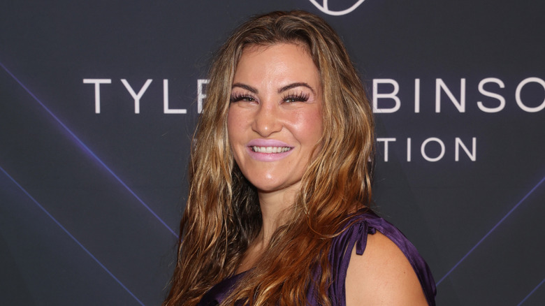 Miesha Tate smiles on a 2023 red carpet.