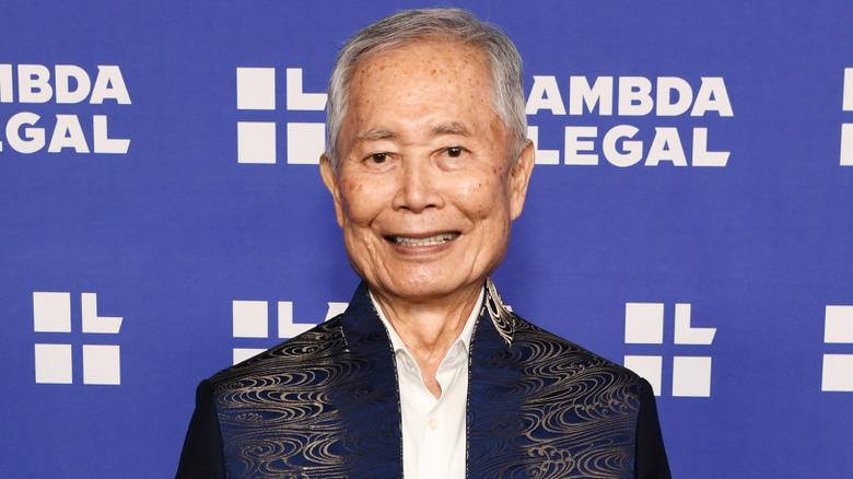 George Takei in a blue jacket