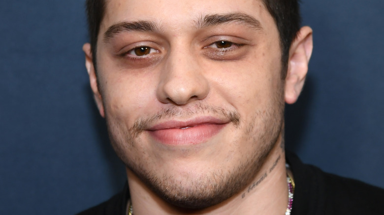 Pete Davidson smiles on the red carpet